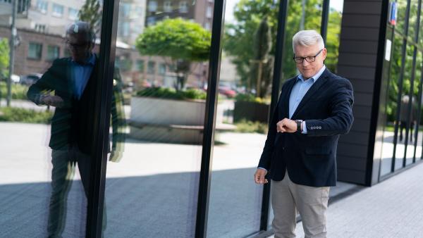 Good looking man looking at watch