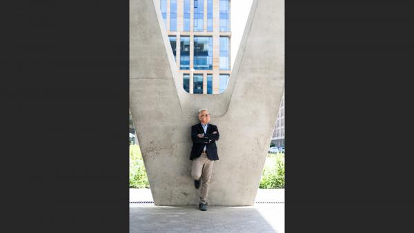 Mature man resting on pilar photo