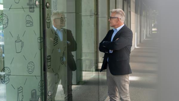 Man looking into shop photo