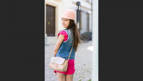 Young girl looking from behind photo