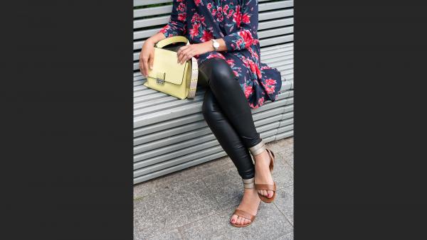Close Up on womans legs and hand bag