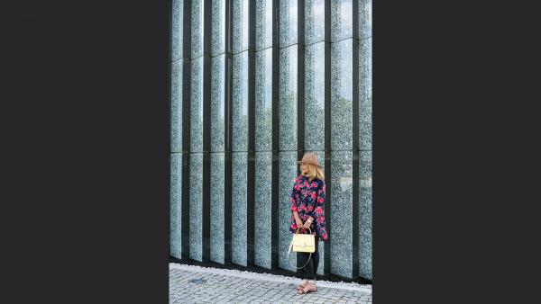 Woman next to glass wall