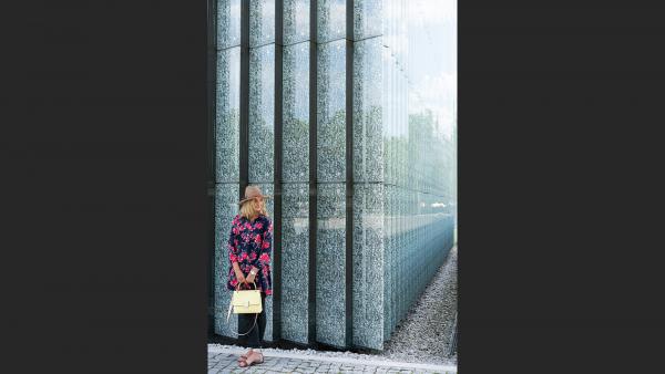 Woman next to beautiful wall