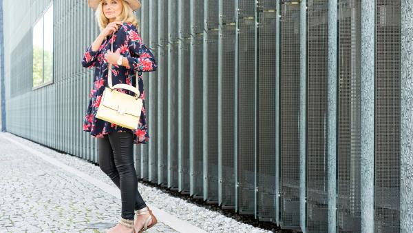 Woman next to glass wall