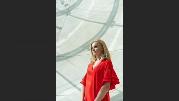 Female in contemporary concrete interior