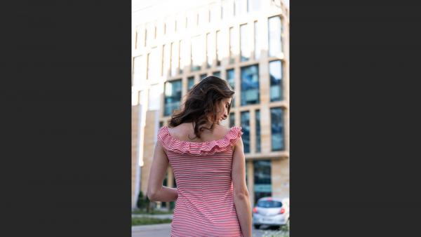 Girl standing back in city center