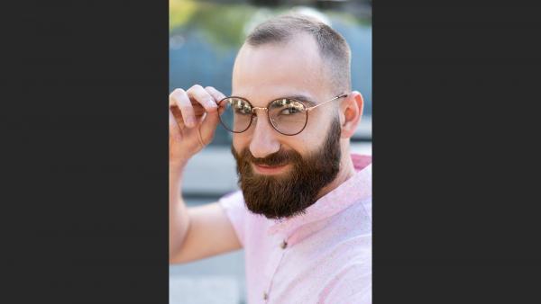 Smart young adult with beard smiling