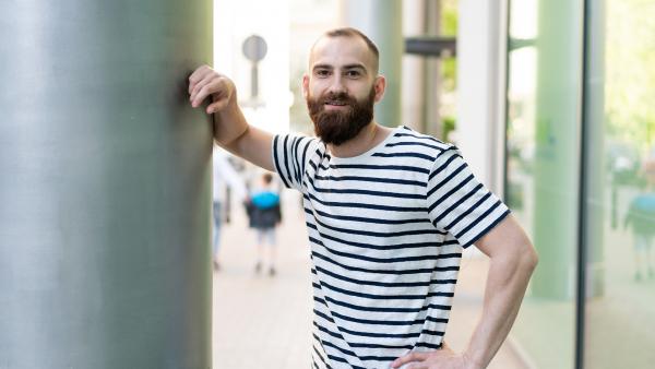 Young male resting hand on pilar