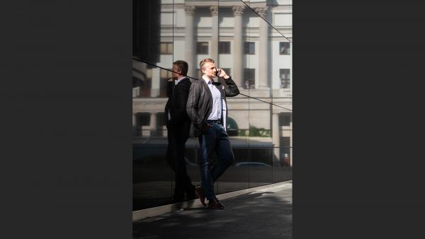 Standing man talking on the phone