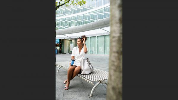 Woman sitting on the bench in shopping mall