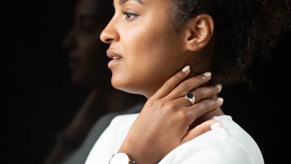 Woman in profile with a ring on her hand