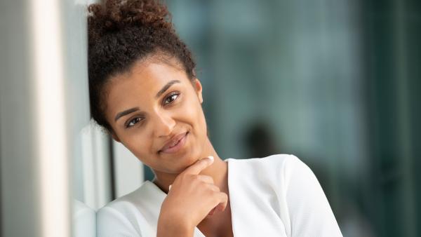 Smiling woman next to glass wall