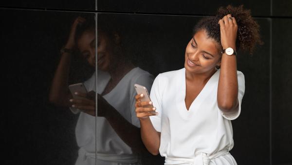 Woman improve hair and looking to phone