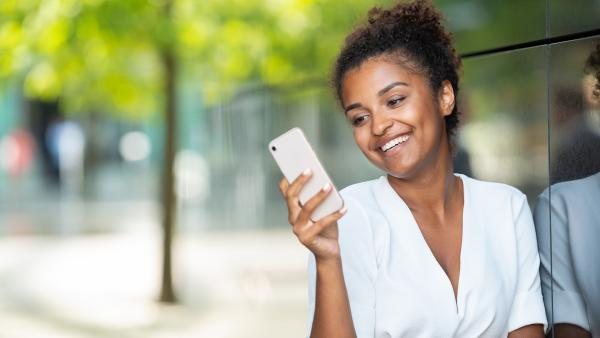 Happy woman look at the phone