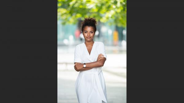 Woman in white summer dress standing