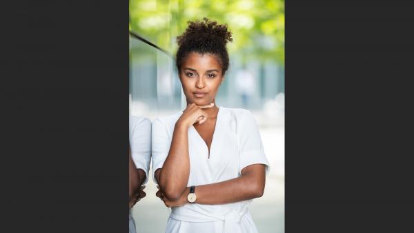 Businesswoman next to glass wall