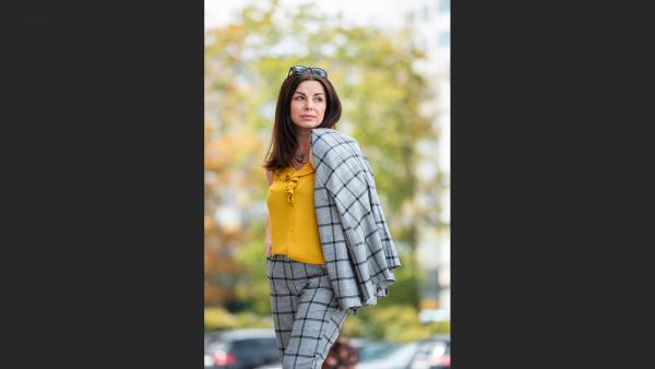 Woman in formal suit standing