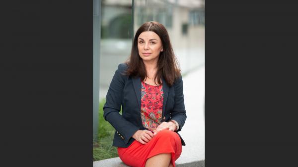 Corporate working woman sitting on the wall