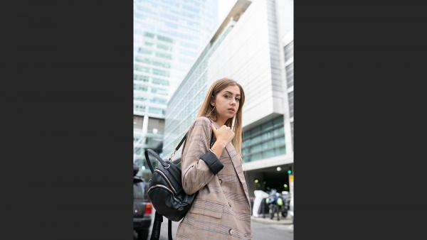 Woman in formal jacket and backpack