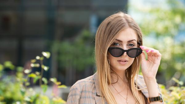 Face of blonde young woman in sunglasses