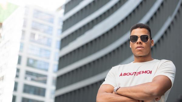 Man in sport shirt next to modern building