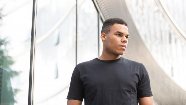 Man standing next to modern building