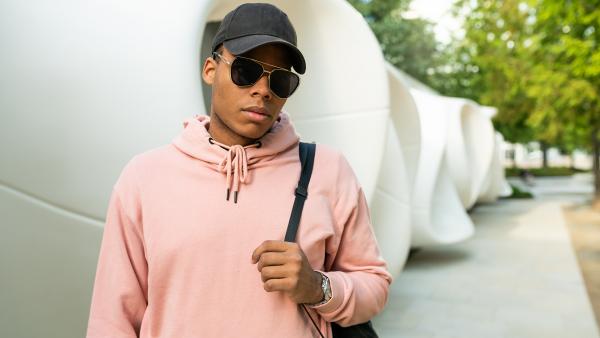 Man with sunglasses, backpack and hoodie